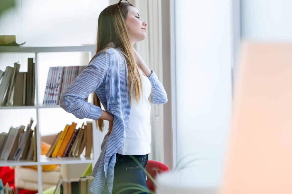 Beautiful young businesswoman taking a break in the office. – Chiropractor for Vertigo in Lehi and Orem Utah